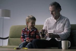 Teaching grandson how to use a Daiwa reel for fishing.