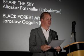 Spencer Hawken reads out the winner at the Eurasian Creative guild Festival