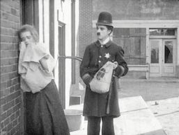 Charles Chaplin and Leota Bryan in Easy Street (1917)
