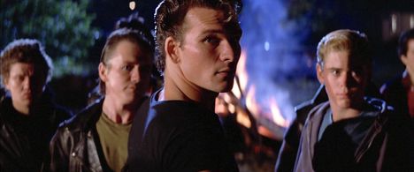 Patrick Swayze, C. Thomas Howell, and Glenn Withrow in The Outsiders (1983)