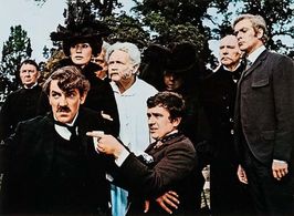 Michael Caine, Dudley Moore, Peter Cook, Irene Handl, John Mills, Nanette Newman, Ralph Richardson, and John Tatham in T