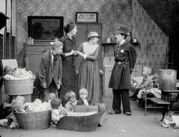 Charles Chaplin, Charlotte Mineau, Edna Purviance, and Loyal Underwood in Easy Street (1917)