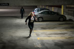 Jennifer Adams (Abigail Breslin) runs away from her masked stalker (Scott Gabelein) in Fear Inc. (2016)