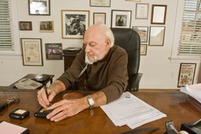 Hilly Elkins on phone in his office