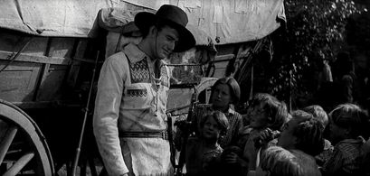 John Wayne, Marilyn Harris, Marion Lessing, Helen Parrish, Robert Parrish, Dannie Mac Grant, and Nancy Crowley in The Bi