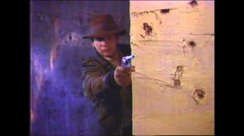 Chris Strompolos as Indiana Jones shoots from cover.