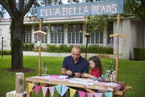Derek Jeter and Ella Grace Helton talk and make Ella Bella Beads bracelets in a commercial for American Family Insurance