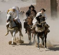 Neera (Biana Tamimi, right) rides hard on Shetan against Mansoor (Ali Al Ameri, center) and Rhamon (Gerard Rudolf, left)