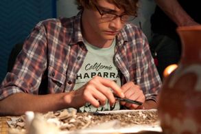 Nathan (Ryan Donowho) sifting through archeological material.