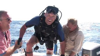Big John Turley greets Keith Neubert as he emerges from the depths of the Caribbean after a successful spearfishing segm