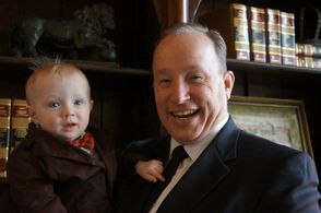 Attorney Steve Sanders holding his youngest son, Asa Sanders.