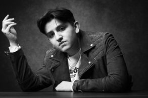 Carlos Lerma on his elbows on a table.