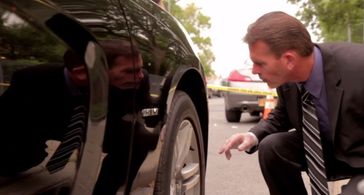 Detective Robert Stewart checking for clues in True Crimes with Aphrodite Jones