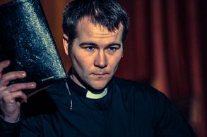 Stuart Brennan giving a sermon in 'The Reverend'.