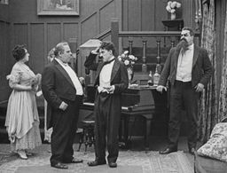 Charles Chaplin, Henry Bergman, Eric Campbell, Marta Golden, and Edna Purviance in The Adventurer (1917)