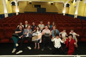 Actor Euan Alexander, child actress Elizabeth Beattie and Jacob Pettifer pose with crew, families and friends after the 