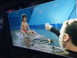 Neel Sethi (Mowgli) and puppeteer Artie Esposito (Baloo the Bear) sing “The Bare Necessities” in 2016’s The Jungle Book