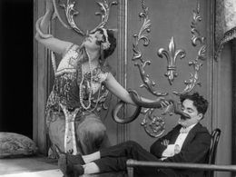 Charles Chaplin and May White in A Night in the Show (1915)