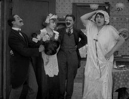 Billy Armstrong, Marta Golden, Edna Purviance, and Leo White in Work (1915)