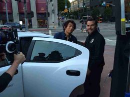Todd Tetreault (Officer Scott) making one of many arrests with Yu Xia (Huang Bolun)