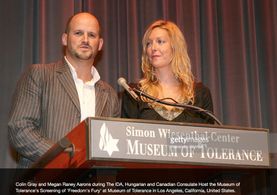 The Sibs (Colin Keith Gray & Megan Raney Aarons) learn they will receive the Order of the Knight's Cross from Hungary at