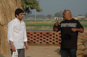 Actor Arbaaz Khan taking direction from Puneet Sira on the set of Kisaan (2009)