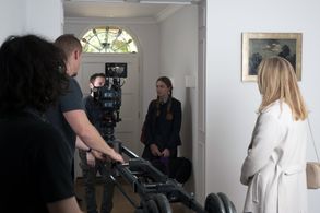 Director Dan Bronzite on set with cast and crew of 