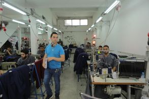 Director Aziz Tazi setting up a shot at a prison factory in Morocco.