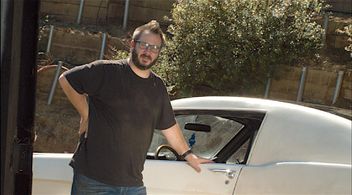 J.P. Riley standing beside the 66 Mustang featured in Mutts' official music video, 