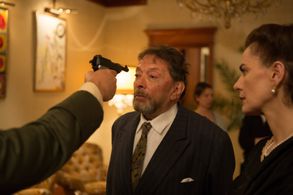 S.S. man Kurt points a gun at Mr. Morgenstern's head (Exodus to Shanghai).