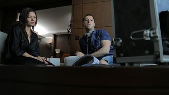 Director Aziz Tazi and Actress Sarah Alami watch the feed of an intimate scene.