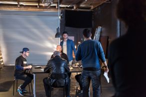 Christopher Kay directing the ensemble cast on set of 