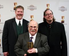 Feature character animation winner Eric Goldberg with presenters John DiMaggio and Fred Tatasciore