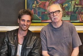 Doug Maguire and John Carpenter pose for a picture.