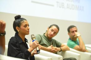 Elghety speaking in a panel discussion on 