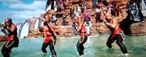 Merchant Tribe Warrior onlooks Dora Milaje