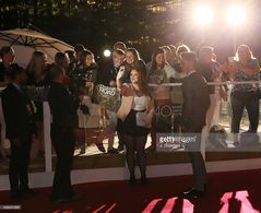 Actor Nikki Duval takes pictures with fans on the red carpet at the premiere of Hyena Road