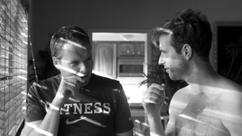 Director Quincy Perkins discusses a shot with Tom Frank on set for Swingers Anonymous