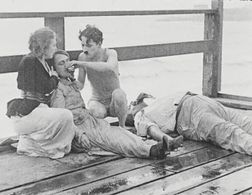 Charles Chaplin, Eric Campbell, Marta Golden, and Edna Purviance in The Adventurer (1917)