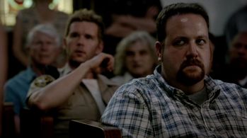 Jason Stackhouse (Ryan Kwanten) and an angry Bon Temps townsperson (Ben Zelevansky) attend a church meeting on 