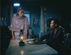 Terry Pheto and Presley Chweneyagae in Tsotsi (2005)