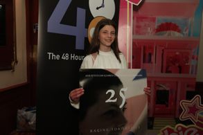 Child actress Elizabeth Beattie poses with film poster before the premiere of 