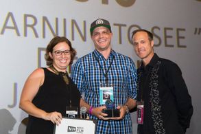 Jake Oelman accepting the Neapolitan Award at the Naples International Film Festival for 'Learning To See - The World Of