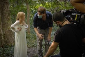 With director and writer John Mathis reviewing scene