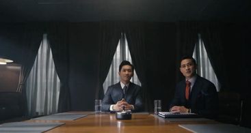 Young Zhang (Ross Kurt Le) and Chen (Eugene Shaw) at an IBM meeting in 1982.