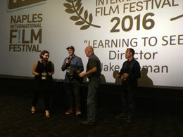 Director Jake Oelman and his father Robert Oelman accepting the Neapolitan Award at the Naples International Film Festiv