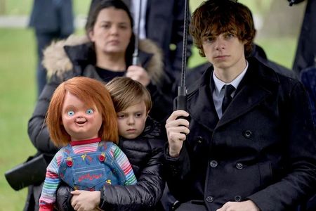 (l-r) Chucky, Callum Vinson as Henry Collins, Jackson Kelly as Grant Collins, Lara Jean Chorostecki as Charlotte Collins