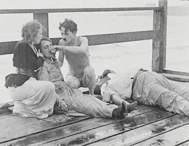 Charles Chaplin, Eric Campbell, Marta Golden, and Edna Purviance in The Adventurer (1917)